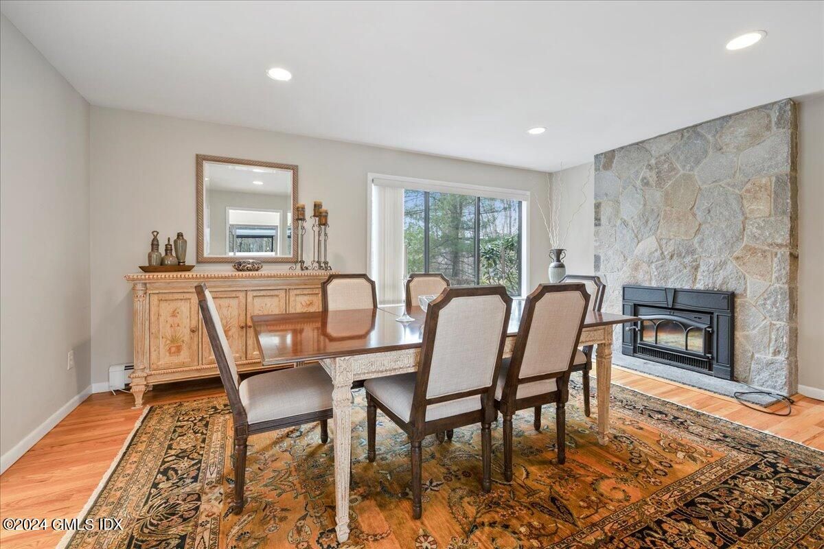 Dining room, Fireplace, Interior, Recessed Lighting, Stone Walls, Wood Texture Flooring