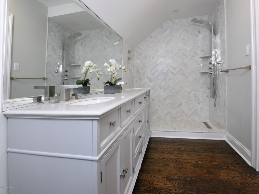 Bathroom, Dual Sink Vanities, Glass Shower, Interior, Marble Walls, Recessed Lighting, Wood Texture Flooring