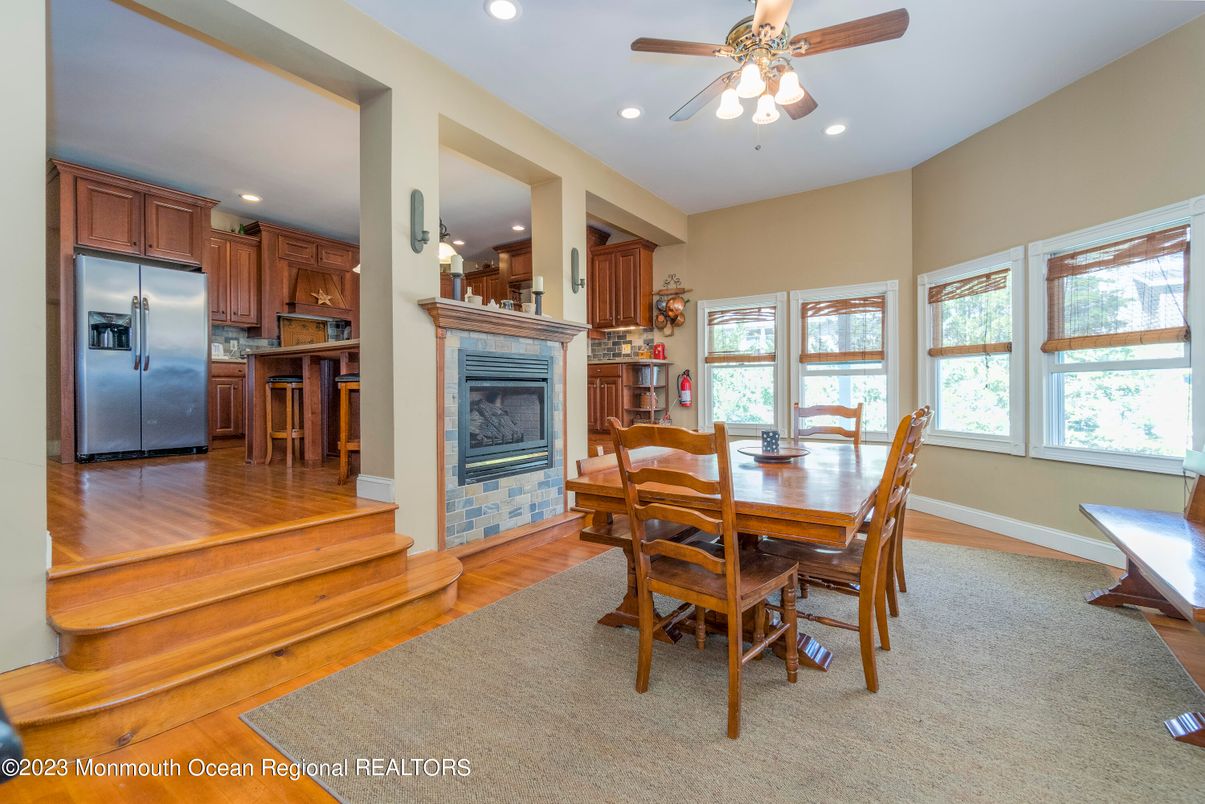 Dining room, Fireplace, Interior, Kitchen, Recessed Lighting, Stainless Steel Appliances, Wood Texture Flooring