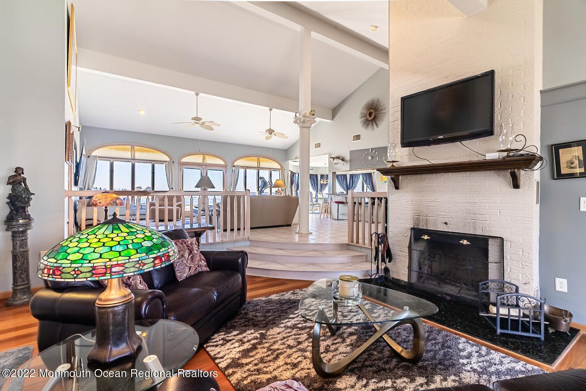 Fireplace, Interior, Living room, Recessed Lighting, Stone Walls, Wood Texture Flooring