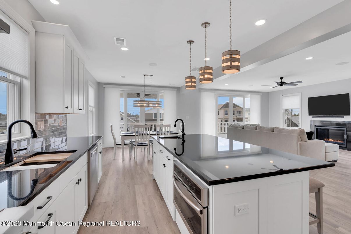 Dining room, Fireplace, Interior, Kitchen, Living room, Pendant Lights, Recessed Lighting, Stainless Steel Appliances, Wood Texture Flooring