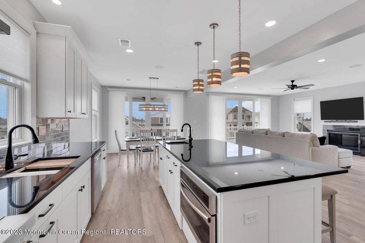 Dining room, Fireplace, Interior, Kitchen, Living room, Pendant Lights, Recessed Lighting, Stainless Steel Appliances, Wood Texture Flooring