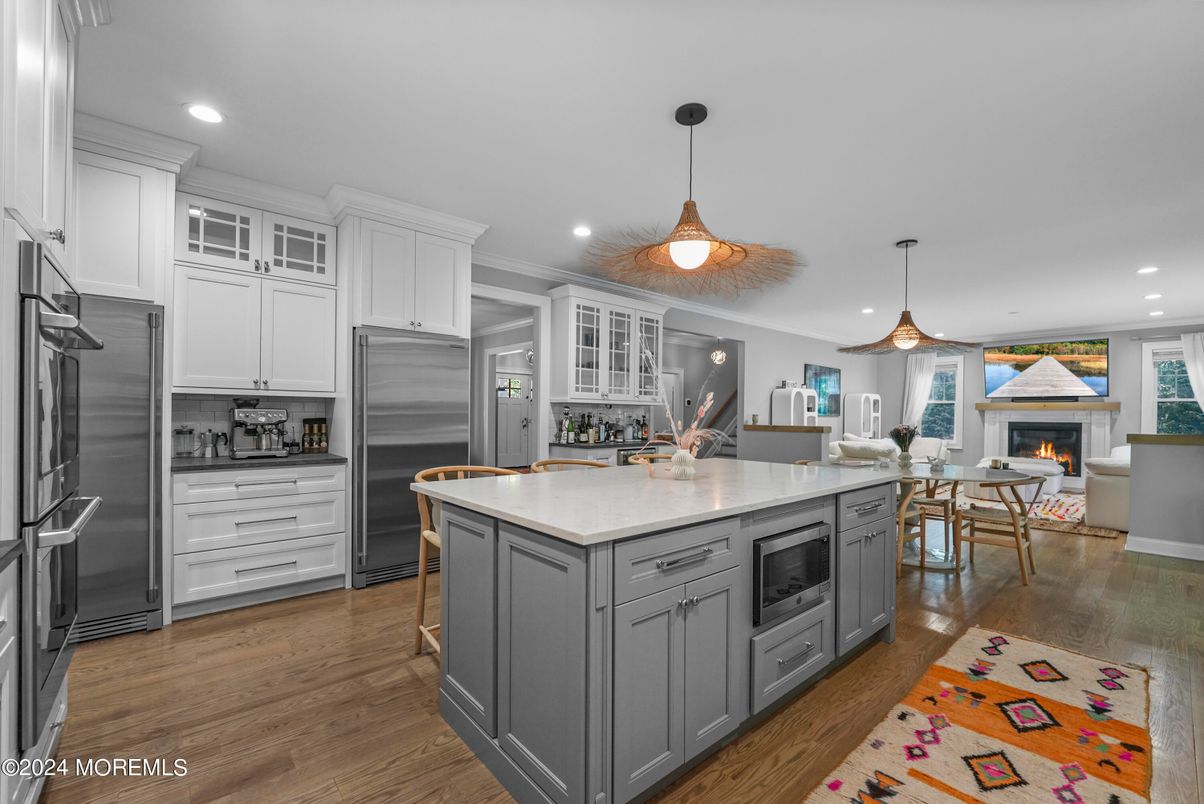 Dining room, Fireplace, Interior, Kitchen, Pendant Lights, Recessed Lighting, Stainless Steel Appliances, Wood Texture Flooring