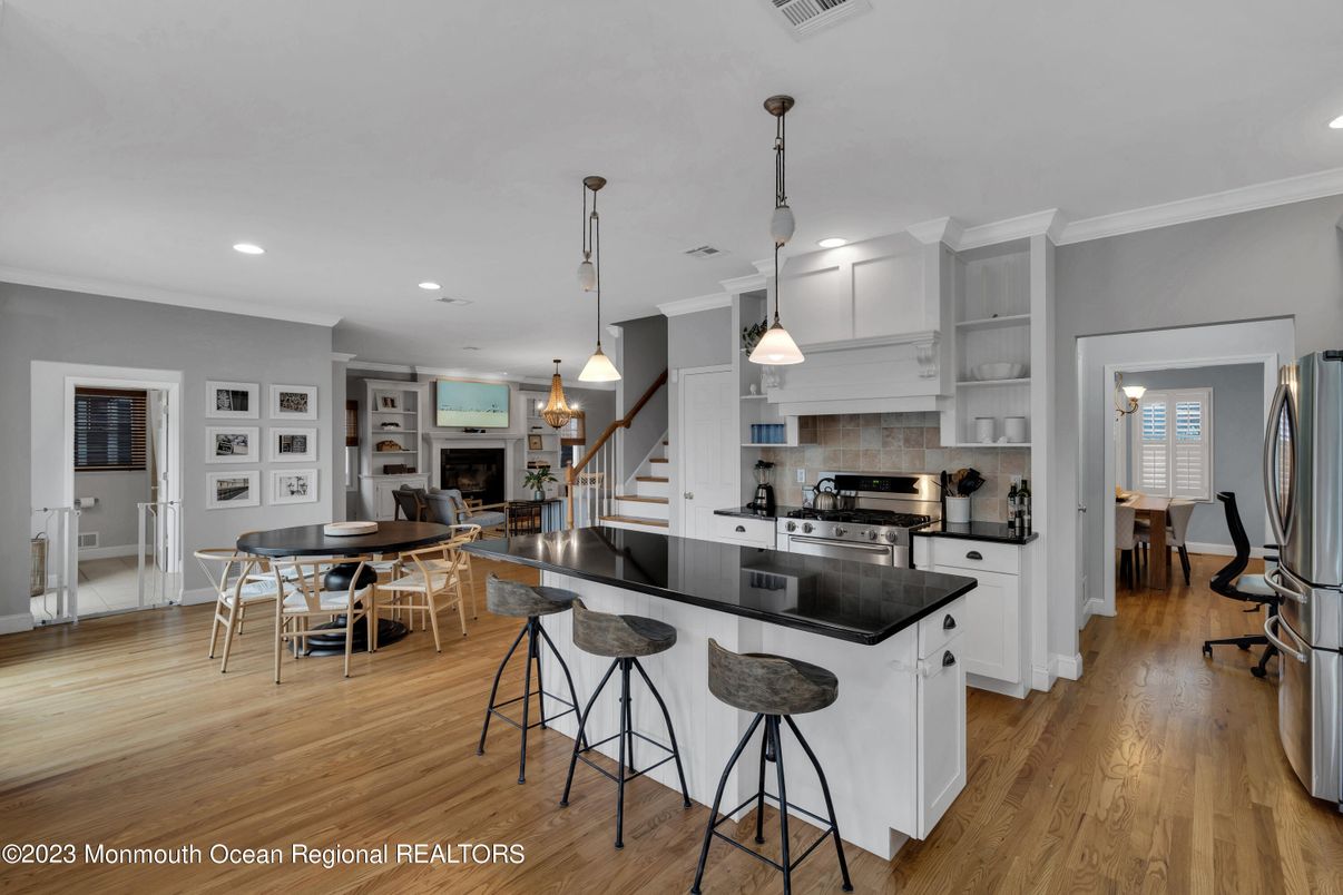 Dining room, Fireplace, Interior, Kitchen, Pendant Lights, Recessed Lighting, Stainless Steel Appliances, Wood Texture Flooring