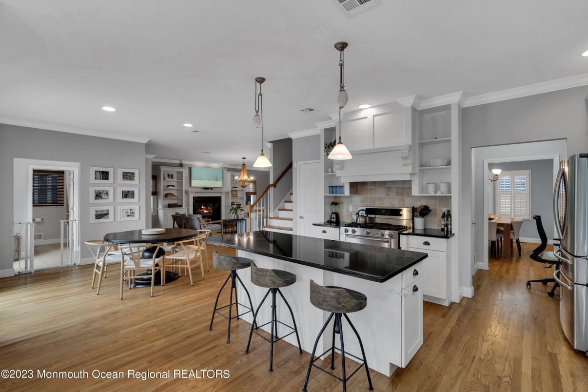 Dining room, Fireplace, Interior, Kitchen, Pendant Lights, Recessed Lighting, Stainless Steel Appliances, Wood Texture Flooring