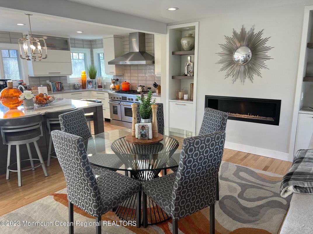 Dining room, Fireplace, Interior, Kitchen, Pendant Lights, Recessed Lighting, Stainless Steel Appliances, Wood Texture Flooring
