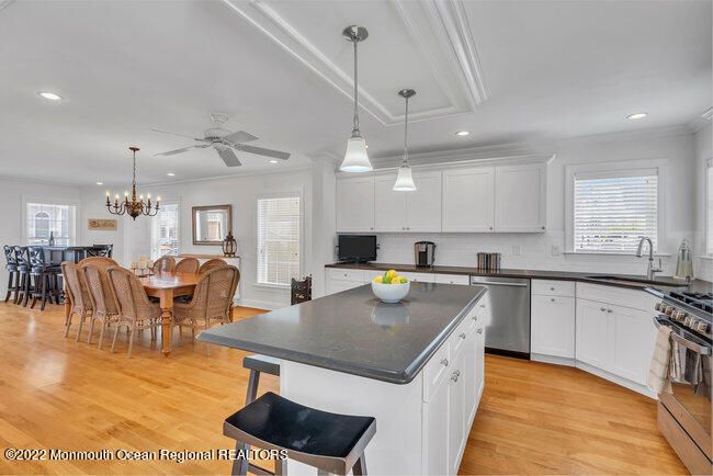 Chandelier, Dining room, Interior, Kitchen, Pendant Lights, Recessed Lighting, Stainless Steel Appliances, Wood Texture Flooring