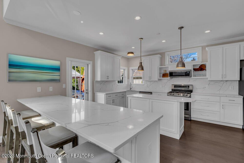 Interior, Kitchen, Marble Walls, Pendant Lights, Recessed Lighting, Stainless Steel Appliances, Wood Texture Flooring