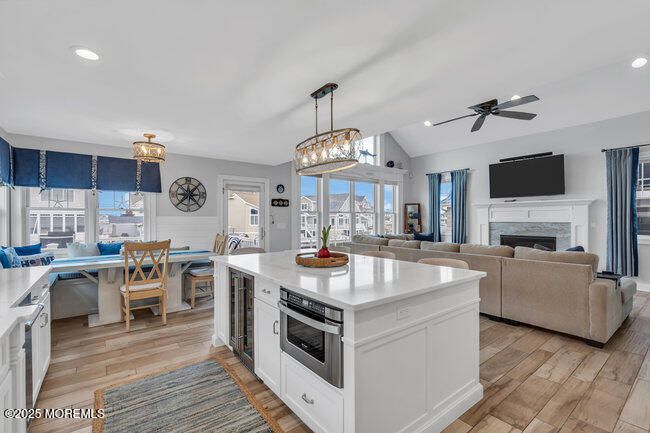 Chandelier, Dining room, Fireplace, Interior, Kitchen, Living room, Pendant Lights, Recessed Lighting, Wood Texture Flooring