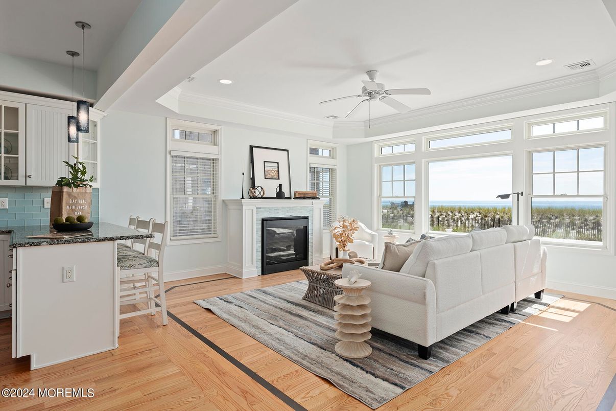 Dining room, Fireplace, Interior, Living room, Pendant Lights, Recessed Lighting, Water, Wood Texture Flooring