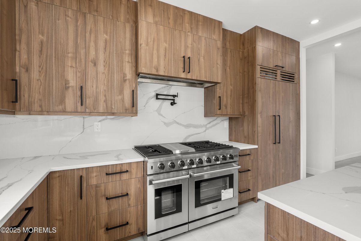 Interior, Kitchen, Marble Walls, Recessed Lighting, Stainless Steel Appliances