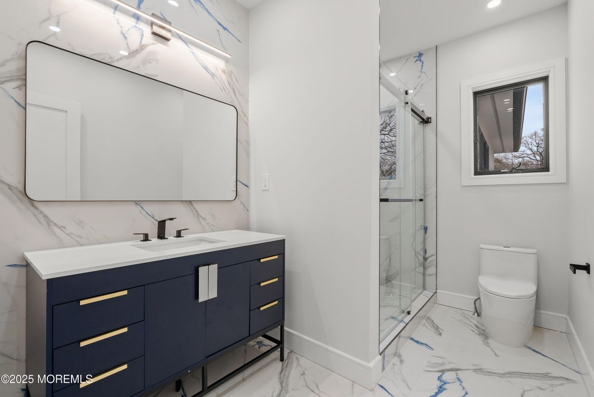 Bathroom, Dual Sink Vanities, Glass Shower, Interior, Marble, Marble Walls, Recessed Lighting