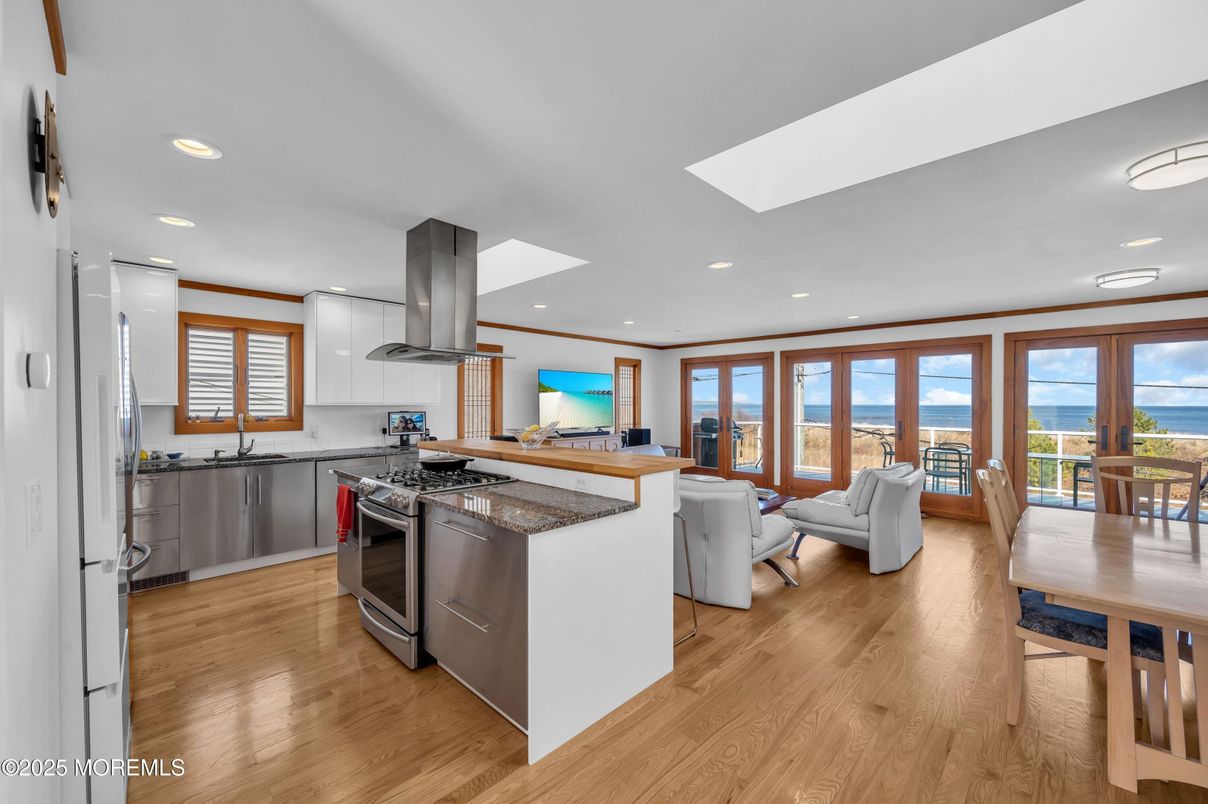 Dining room, Interior, Kitchen, Living room, Recessed Lighting, Water, Wood Texture Flooring