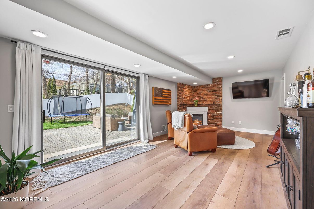Fireplace, Interior, Living room, Recessed Lighting, Stone Walls, Wood Texture Flooring