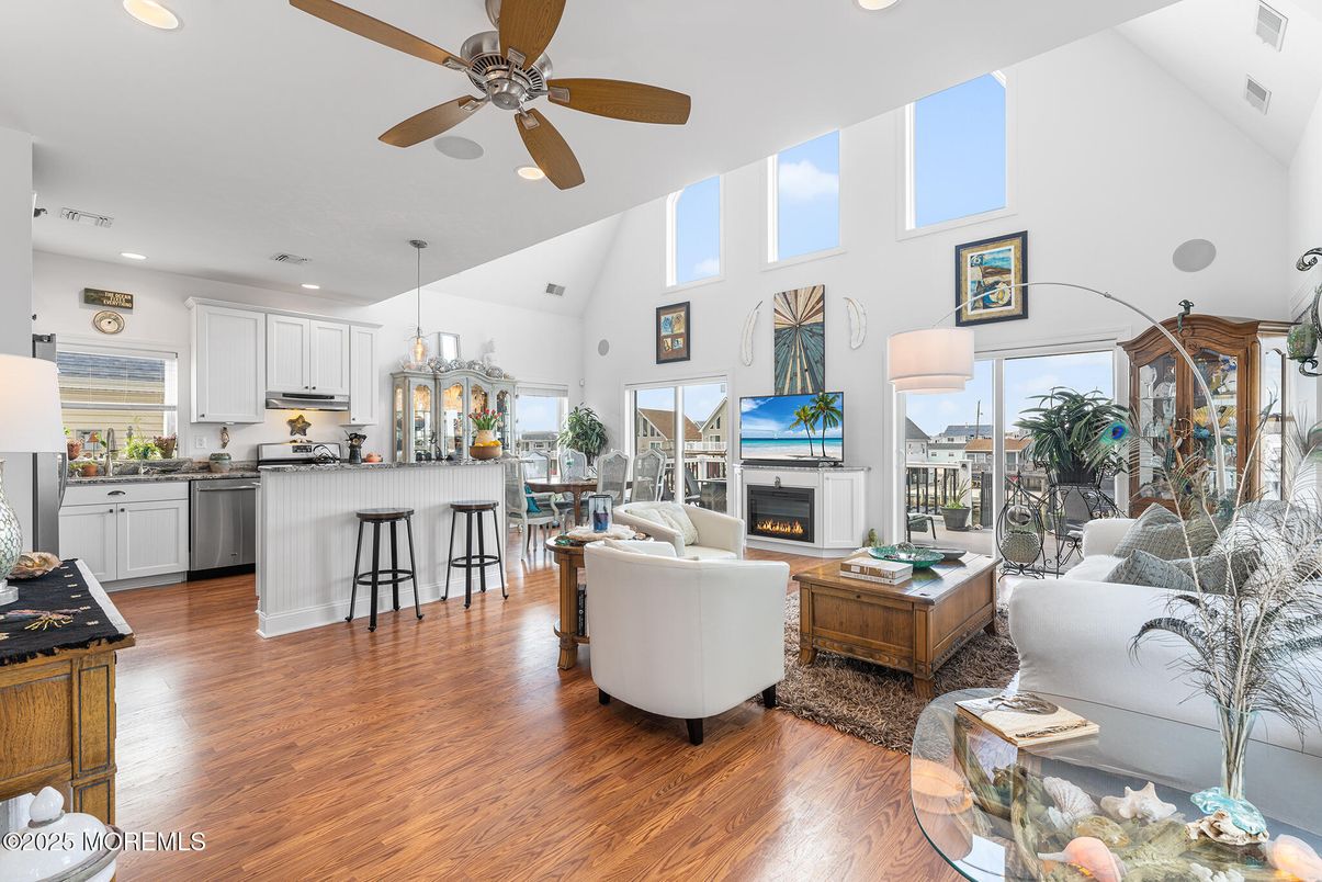 Fireplace, Interior, Kitchen, Living room, Pendant Lights, Recessed Lighting, Stainless Steel Appliances, Wood Texture Flooring