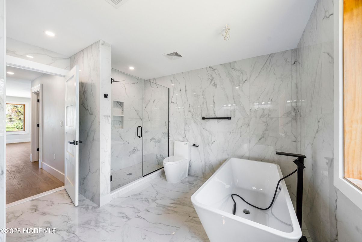 Bathroom, Free Standing Baths, Glass Shower, Interior, Marble, Marble Walls, Recessed Lighting, Wood Texture Flooring