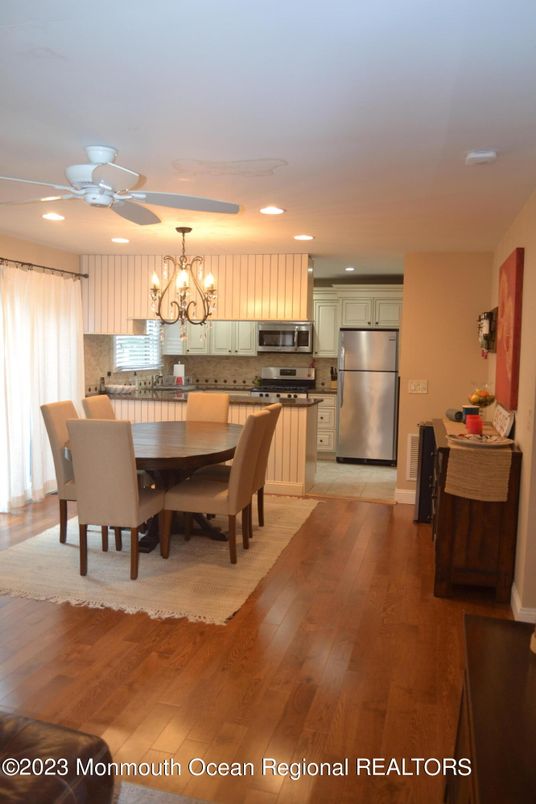 Chandelier, Dining room, Interior, Kitchen, Recessed Lighting, Stainless Steel Appliances, Wood Texture Flooring
