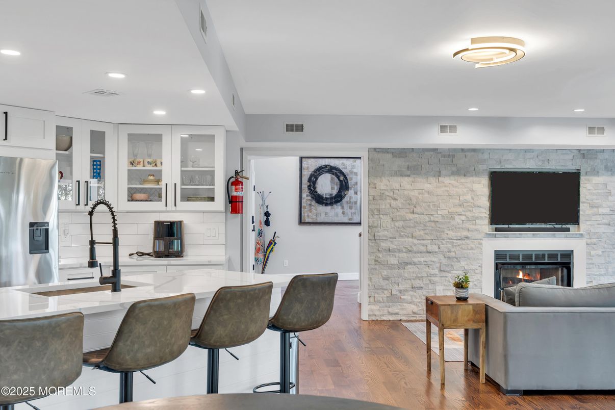 Fireplace, Interior, Kitchen, Living room, Recessed Lighting, Stainless Steel Appliances, Stone Walls, Wood Texture Flooring
