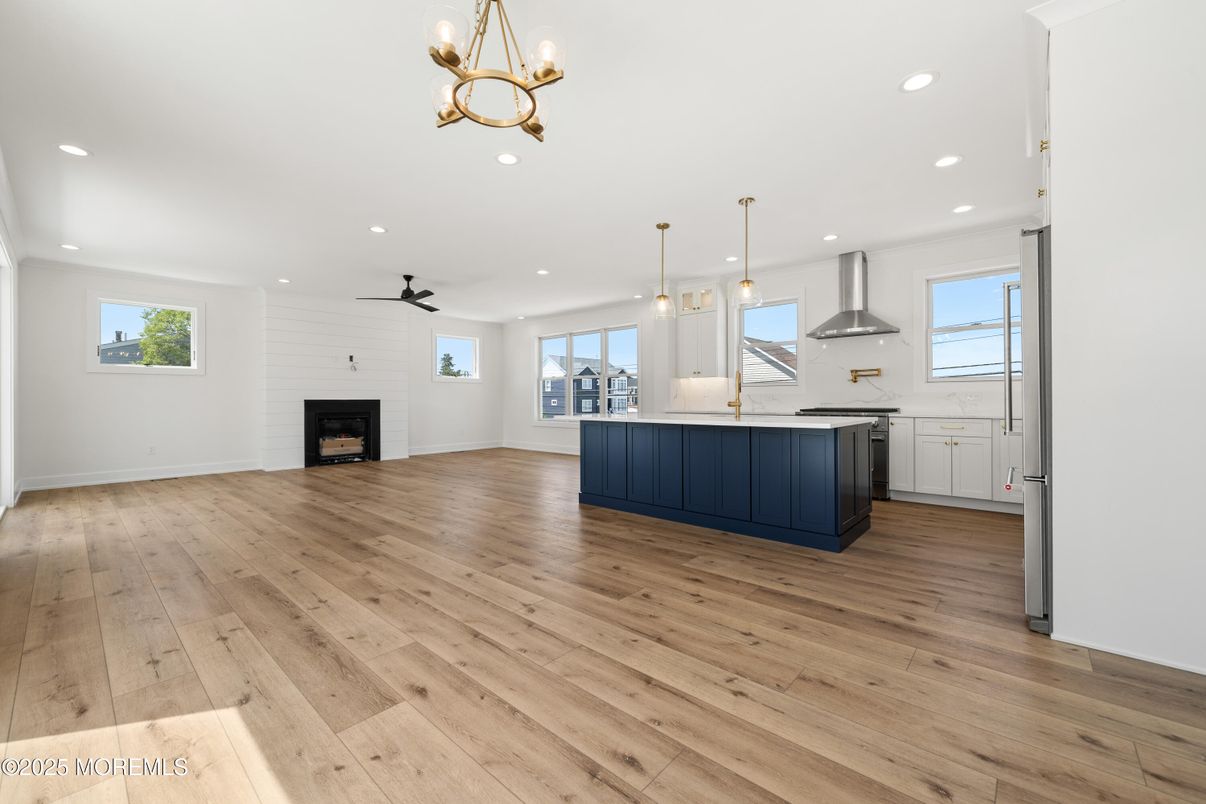 Empty room, Fireplace, Interior, Kitchen, Pendant Lights, Recessed Lighting, Wood Texture Flooring