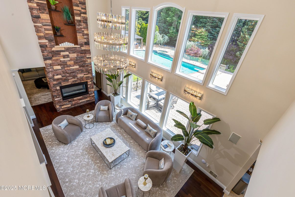 Chandelier, Dining room, Fireplace, Interior, Living room, Stone Walls, Wood Texture Flooring