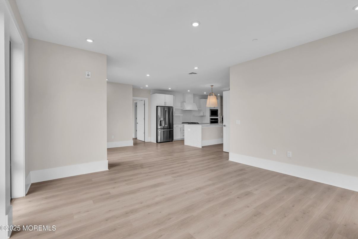 Empty room, Interior, Kitchen, Pendant Lights, Recessed Lighting, Stainless Steel Appliances, Wood Texture Flooring