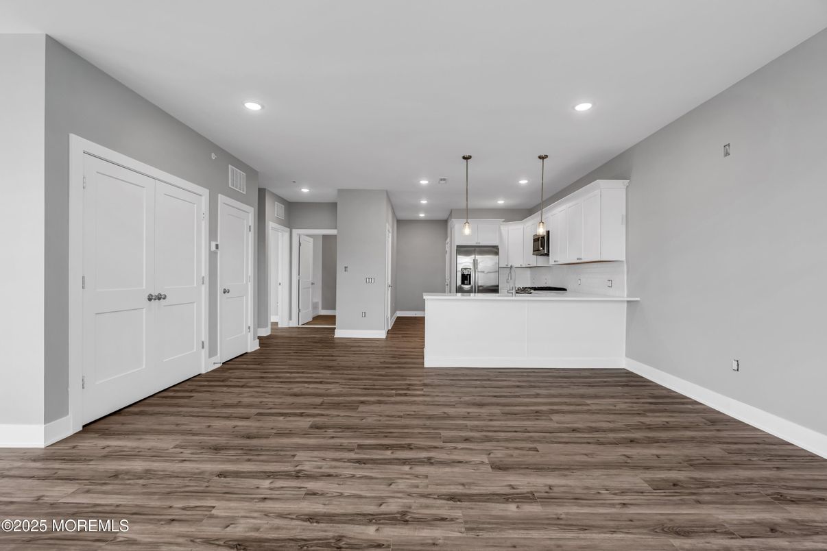 Empty room, Interior, Kitchen, Pendant Lights, Recessed Lighting, Stainless Steel Appliances, Wood Texture Flooring