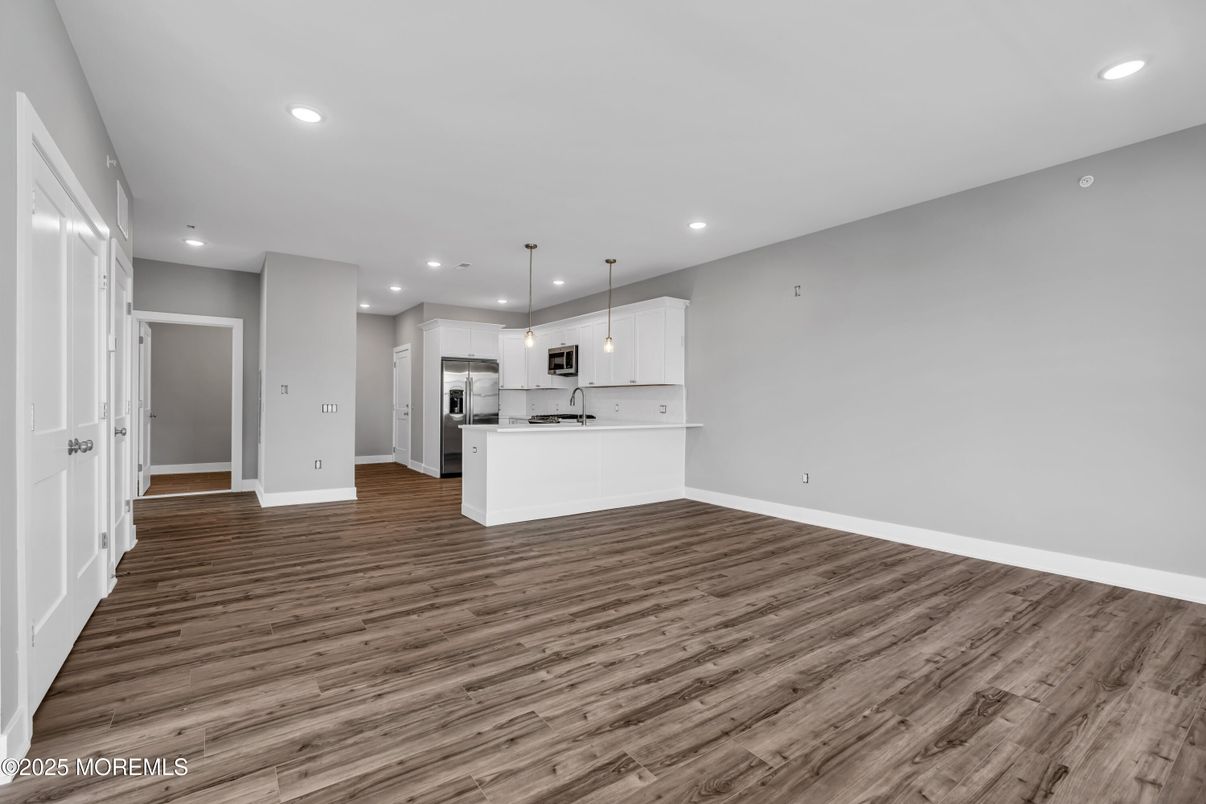 Empty room, Interior, Kitchen, Pendant Lights, Recessed Lighting, Stainless Steel Appliances, Wood Texture Flooring