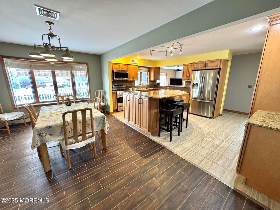 Chandelier, Dining room, Interior, Kitchen, Recessed Lighting, Stainless Steel Appliances, Wood Texture Flooring