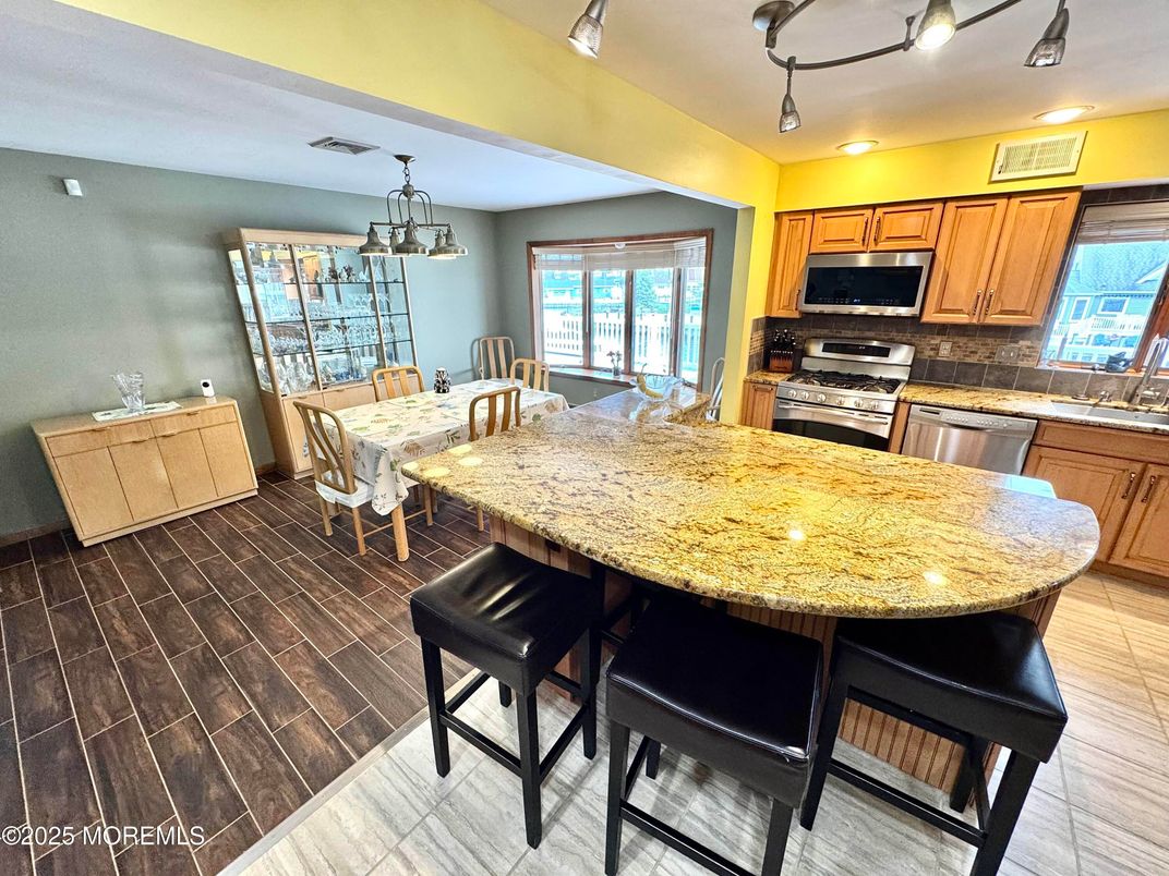 Chandelier, Dining room, Interior, Kitchen, Pendant Lights, Stainless Steel Appliances, Wood Texture Flooring
