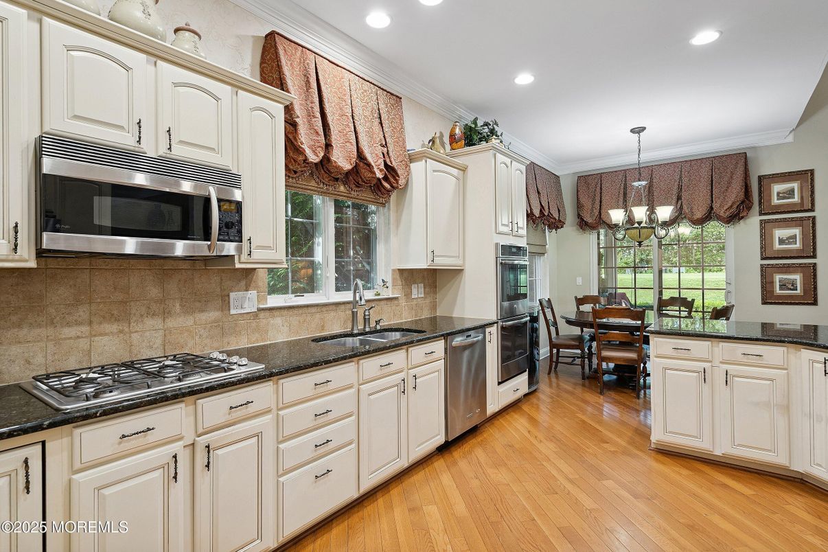 Chandelier, Dining room, Interior, Kitchen, Recessed Lighting, Stainless Steel Appliances, Wood Texture Flooring