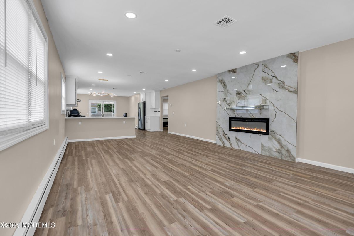 Empty room, Fireplace, Interior, Marble Walls, Recessed Lighting, Wood Texture Flooring