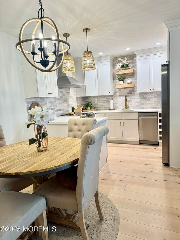 Chandelier, Dining room, Interior, Kitchen, Pendant Lights, Recessed Lighting, Stainless Steel Appliances, Stone Walls, Wood Texture Flooring