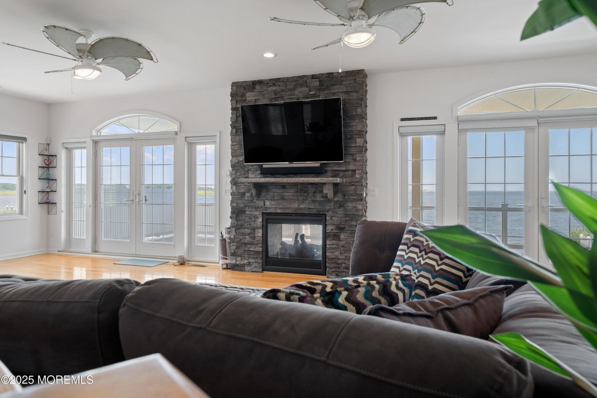 Fireplace, Interior, Living room, Recessed Lighting, Stone Walls, Wood Texture Flooring