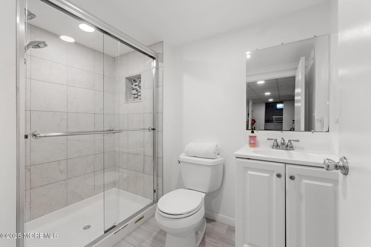 Bathroom, Glass Shower, Interior, Marble Walls, Recessed Lighting, Wood Texture Flooring