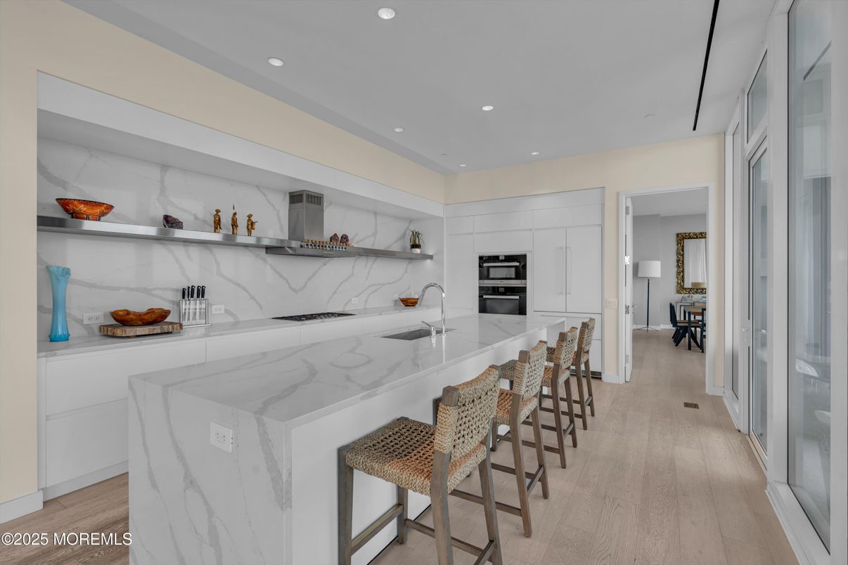 Interior, Kitchen, Marble Walls, Recessed Lighting, Stainless Steel Appliances, Wood Texture Flooring