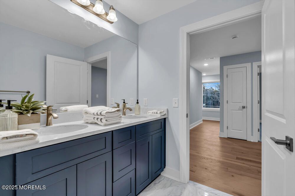 Bathroom, Dual Sink Vanities, Interior, Marble, Recessed Lighting, Wood Texture Flooring