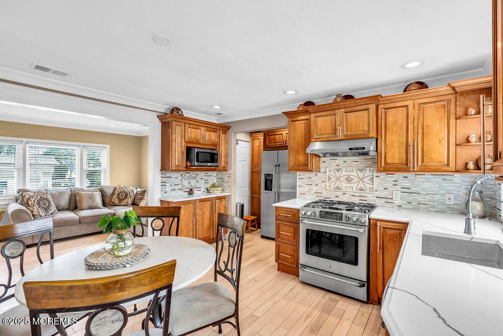 Dining room, Interior, Kitchen, Living room, Recessed Lighting, Stainless Steel Appliances, Wood Texture Flooring