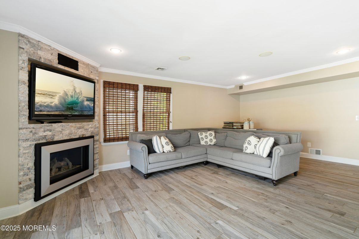 Fireplace, Interior, Living room, Recessed Lighting, Stone Walls, Wood Texture Flooring