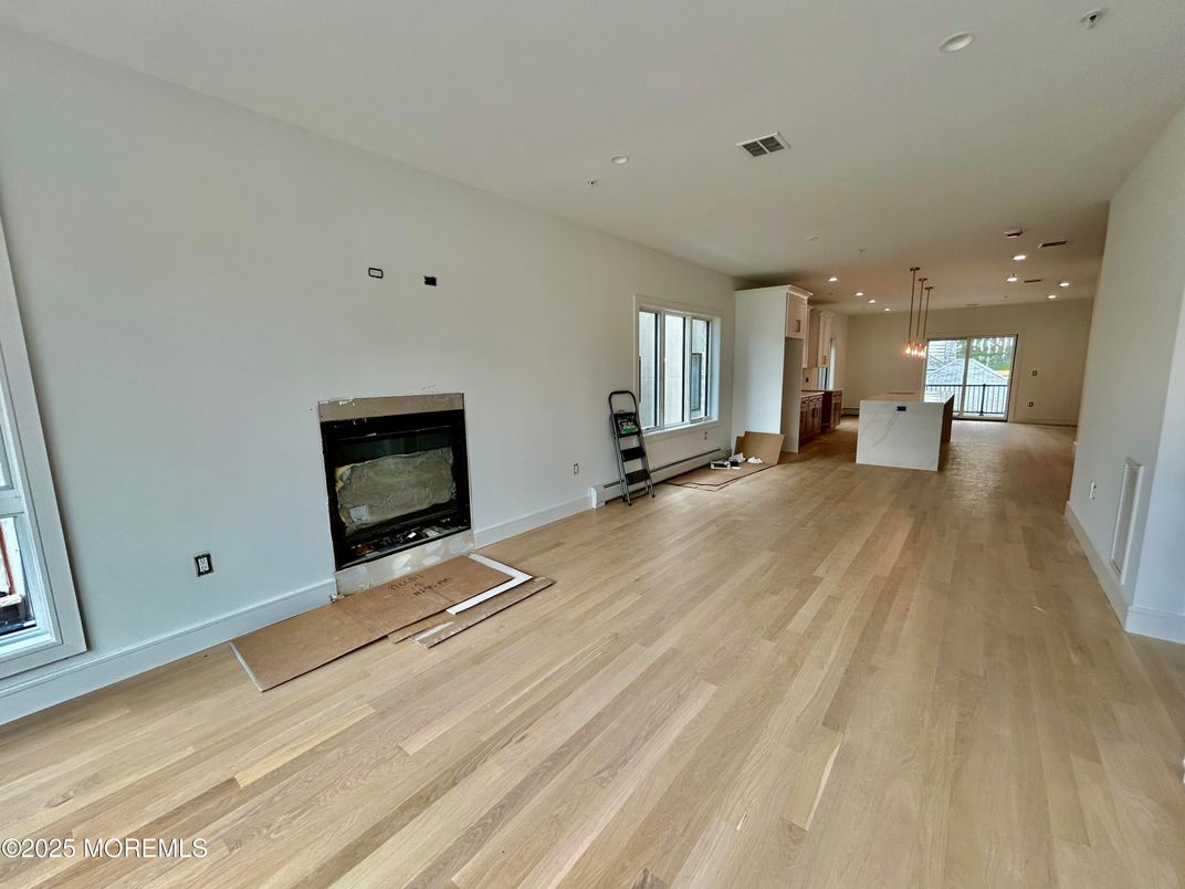 Empty room, Fireplace, Interior, Kitchen, Pendant Lights, Recessed Lighting, Wood Texture Flooring