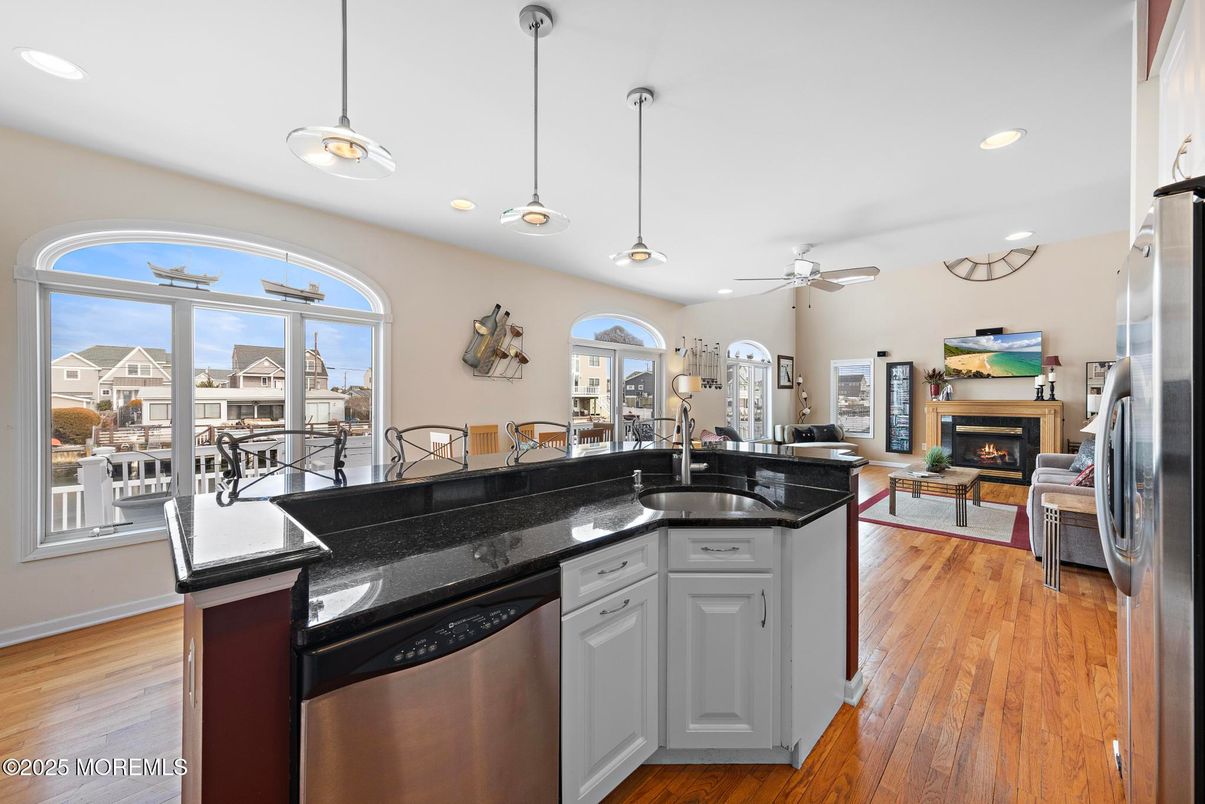 Dining room, Fireplace, Interior, Kitchen, Living room, Pendant Lights, Recessed Lighting, Stainless Steel Appliances, Wood Texture Flooring