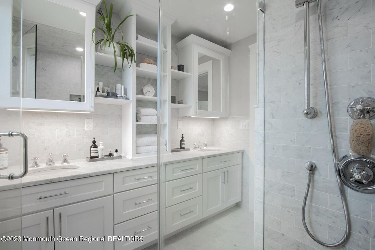 Bathroom, Dual Sink Vanities, Glass Shower, Interior, Marble Walls, Recessed Lighting