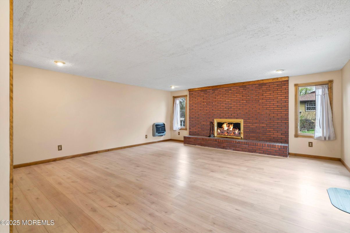 Empty room, Fireplace, Interior, Recessed Lighting, Stone Walls, Wood Texture Flooring