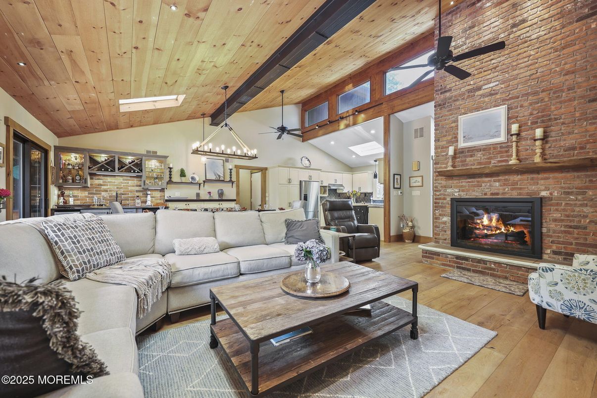 Chandelier, Dining room, Fireplace, Interior, Kitchen, Living room, Pendant Lights, Recessed Lighting, Stainless Steel Appliances, Stone Walls, Wooden Beams, Wooden Ceilings, Wood Texture Flooring