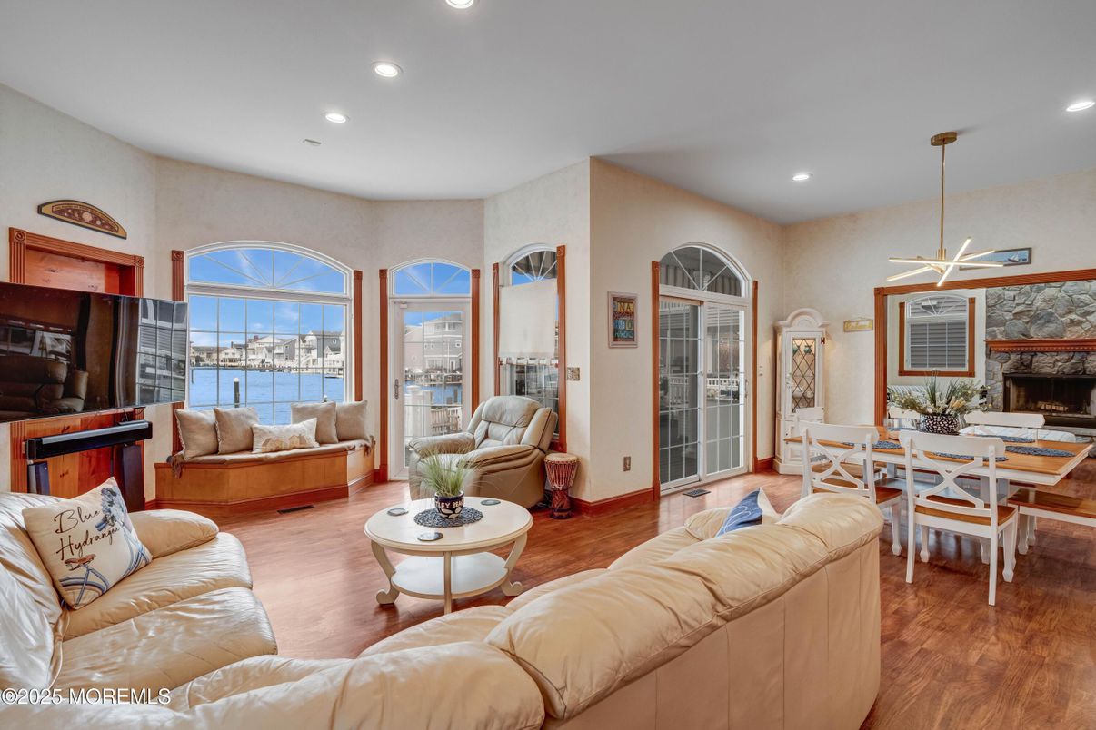 Dining room, Fireplace, Interior, Living room, Pendant Lights, Recessed Lighting, Water, Wood Texture Flooring