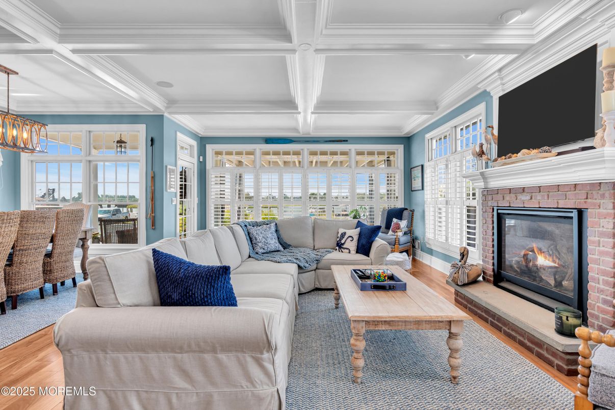 Chandelier, Dining room, Fireplace, Interior, Living room, Pendant Lights, Recessed Lighting, Wood Texture Flooring