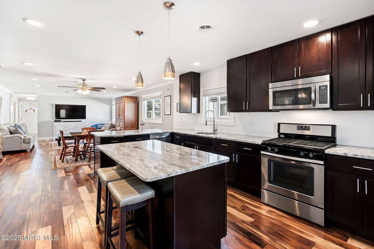 Dining room, Interior, Kitchen, Pendant Lights, Recessed Lighting, Stainless Steel Appliances, Wood Texture Flooring