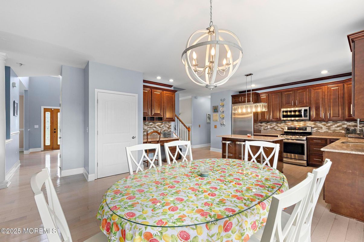 Chandelier, Dining room, Interior, Kitchen, Pendant Lights, Recessed Lighting, Stainless Steel Appliances, Wood Texture Flooring