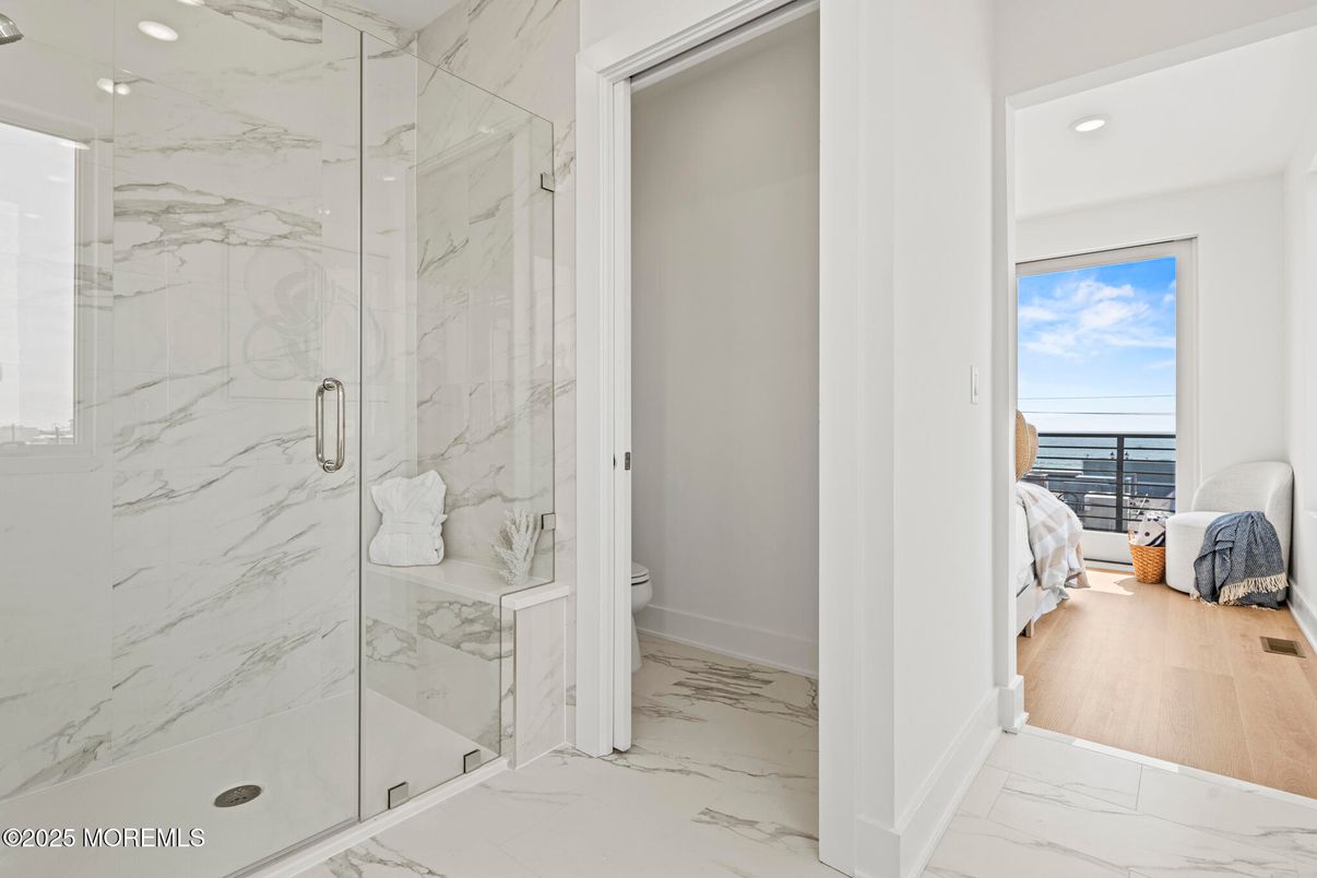 Bathroom, Glass Shower, Interior, Marble, Marble Walls, Recessed Lighting, Water, Wood Texture Flooring