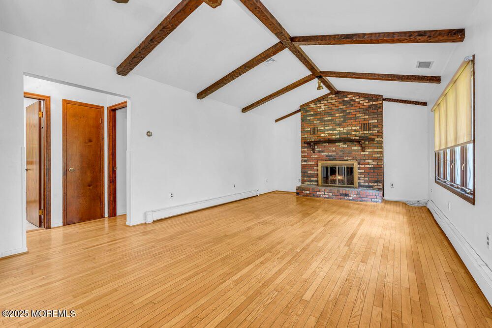 Empty room, Fireplace, Interior, Stone Walls, Wooden Beams, Wood Texture Flooring