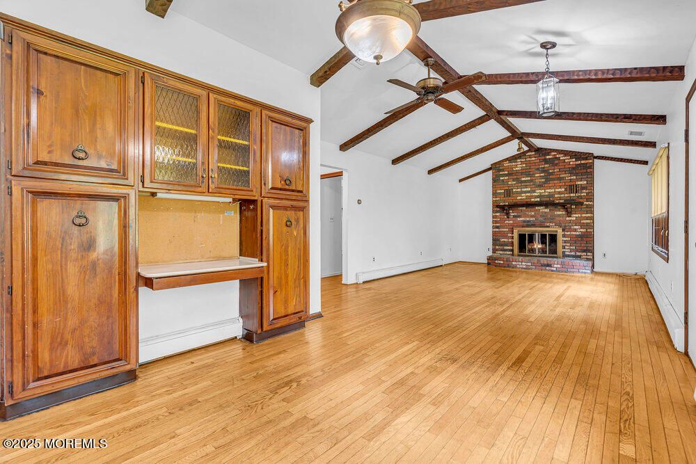 Empty room, Fireplace, Interior, Pendant Lights, Stone Walls, Wooden Beams, Wood Texture Flooring